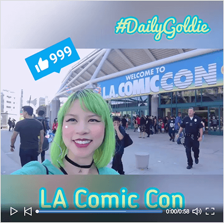Това е екранна снимка на видеоклип на Goldie Chan LinkedIn със стартов екран. Видеото е заснето хоризонтално на смартфон и е превърнато в квадратно видео с размазани пощенски кутии над и под видеото. Стартовото видео изображение показва Голди пред конгресния център за LA Comic Con. Голди се появява от раменете нагоре. Тя е азиатка със зелена коса. Тя е с грим, черна колие-чокър и тюркоазена риза. В областта на пощенската кутия над видеоклипа #DailyGoldie се появява в светло зелен шрифт на скрипта с тюркоазен контур. Икона LinkedIn Like с номер 999 се появява в синьо поле над главата на Goldie. В областта на пощенската кутия под видеото текстът „LA Comic Con“ се появява в светло зелен шрифт san serif с тюркоазен контур.